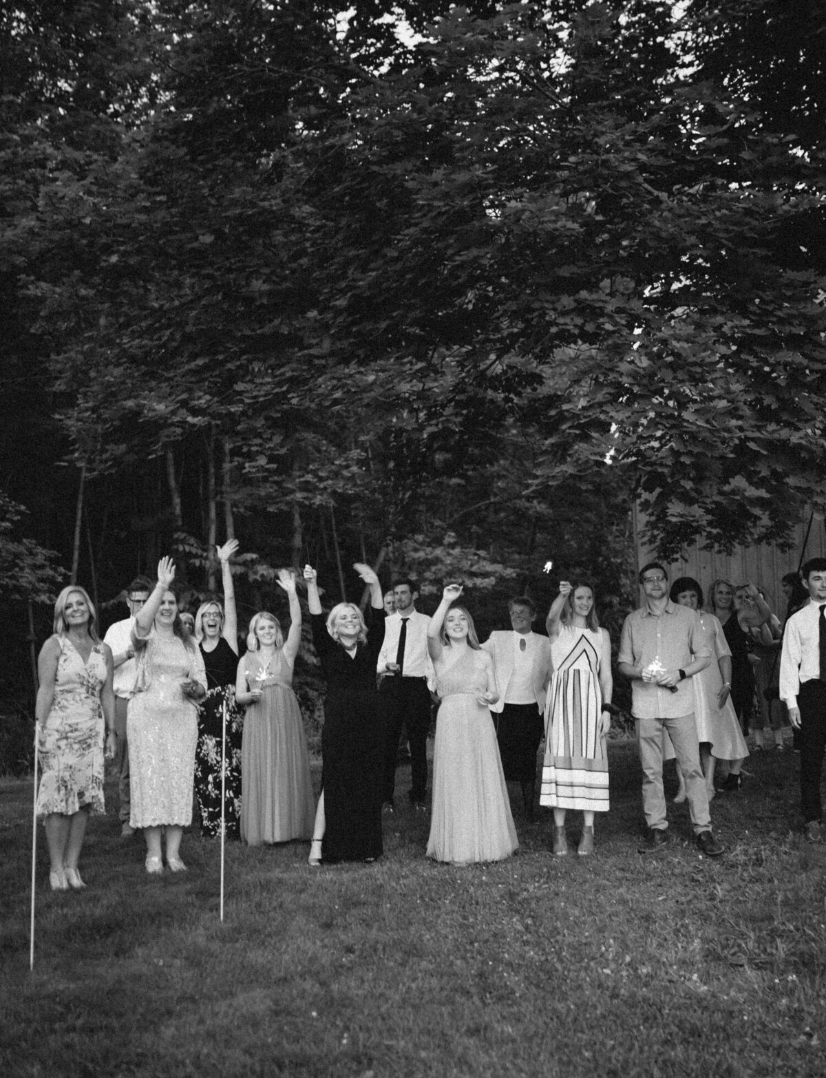 guests wave goodbye to bride and groom at Glass House wedding in Michigan