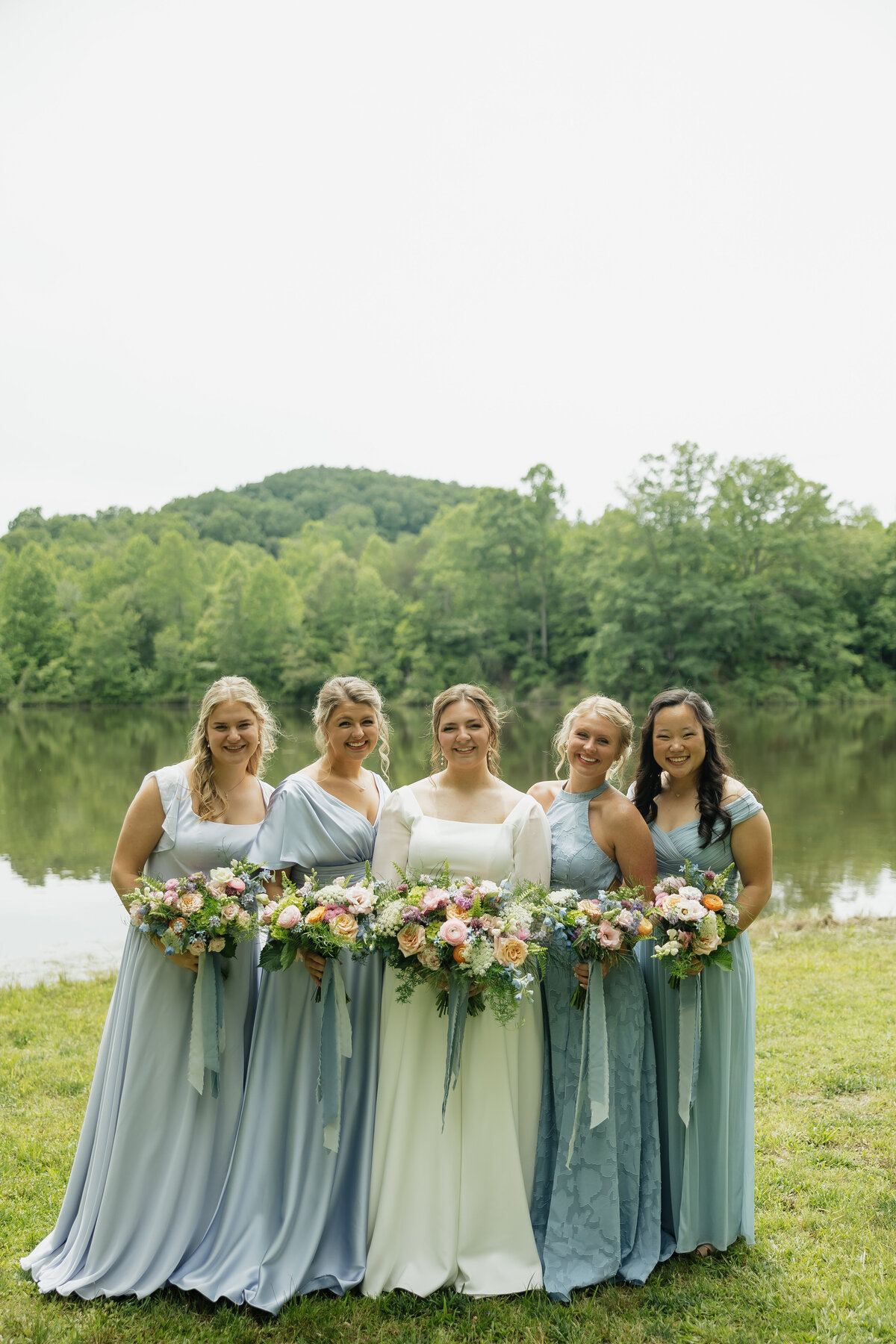 Bride and bridesmaids with colorful bouquets designed by Abby Grace Florals at Dahlonega GA wedding