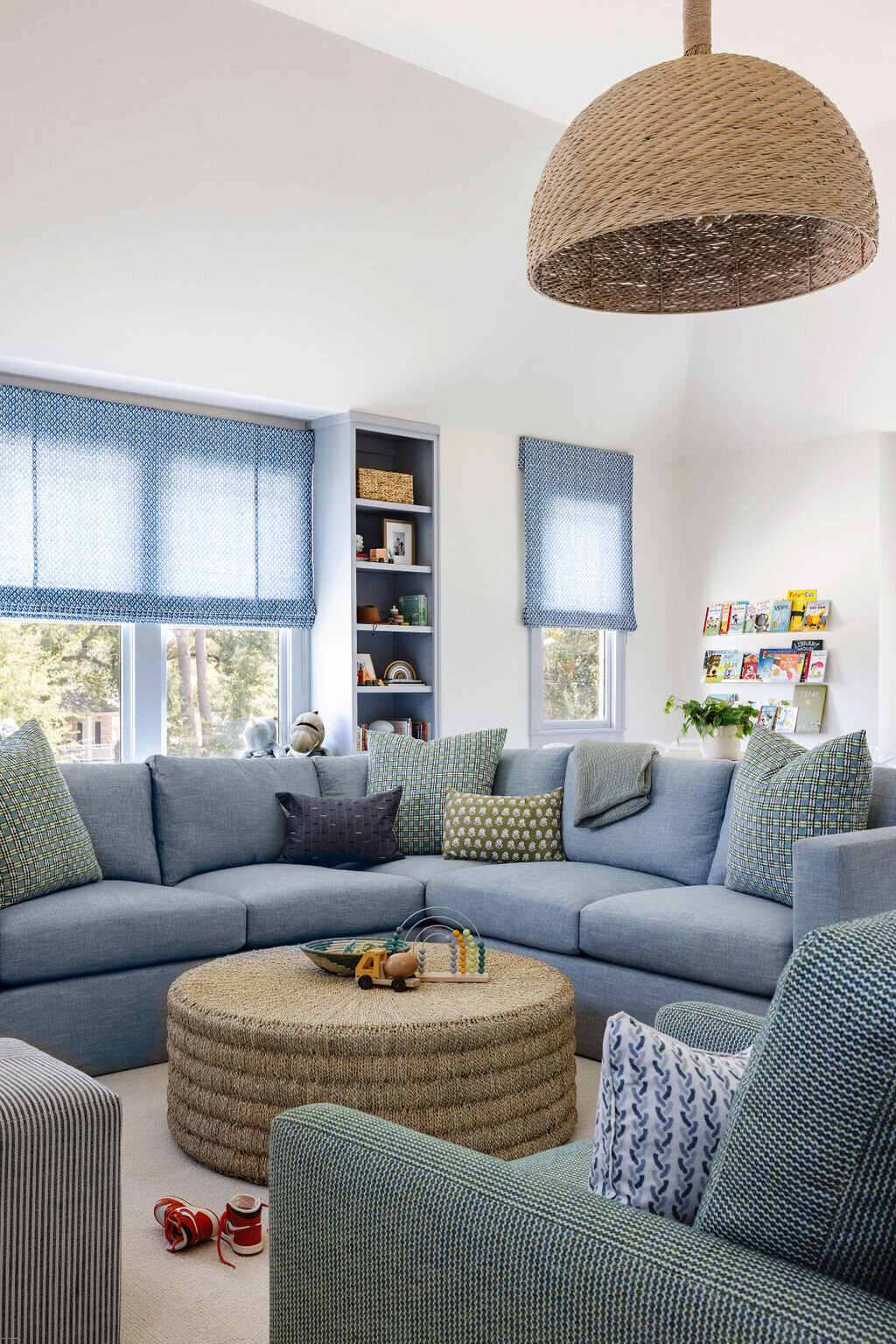 oyster creek studios stripling new build blue couch and rattan coffee table