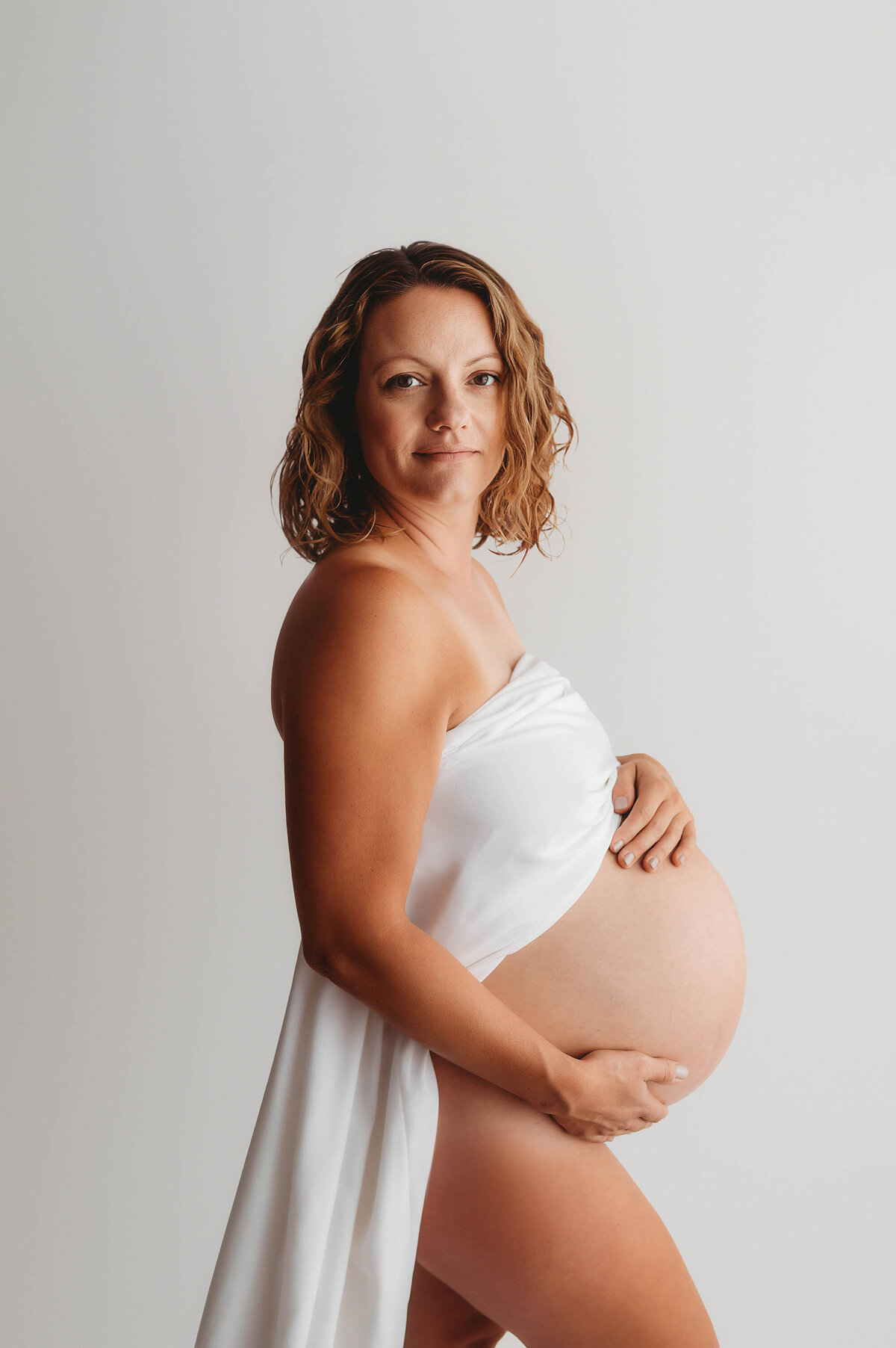 Pregnant woman poses for Editorial, Studio Maternity Photos in Charleston, SC.