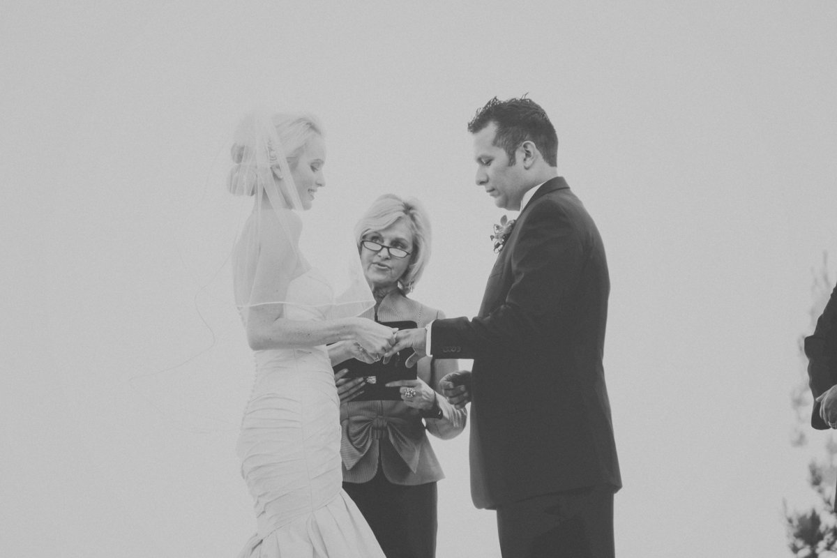 black and white photo of bride and groom exchanging rings at the wedding ceremony | Susie Moreno Photography