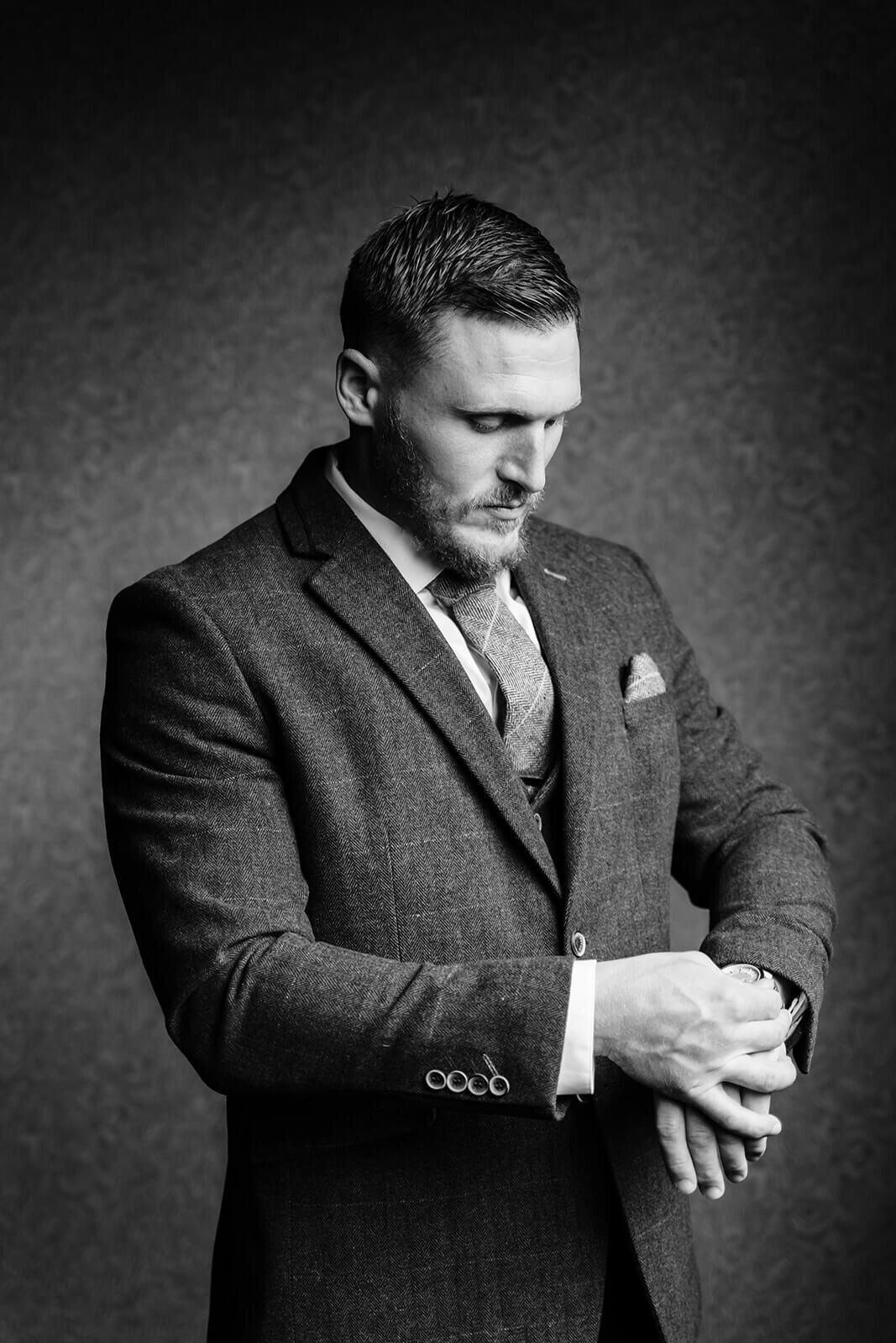 Groom adjusting watch