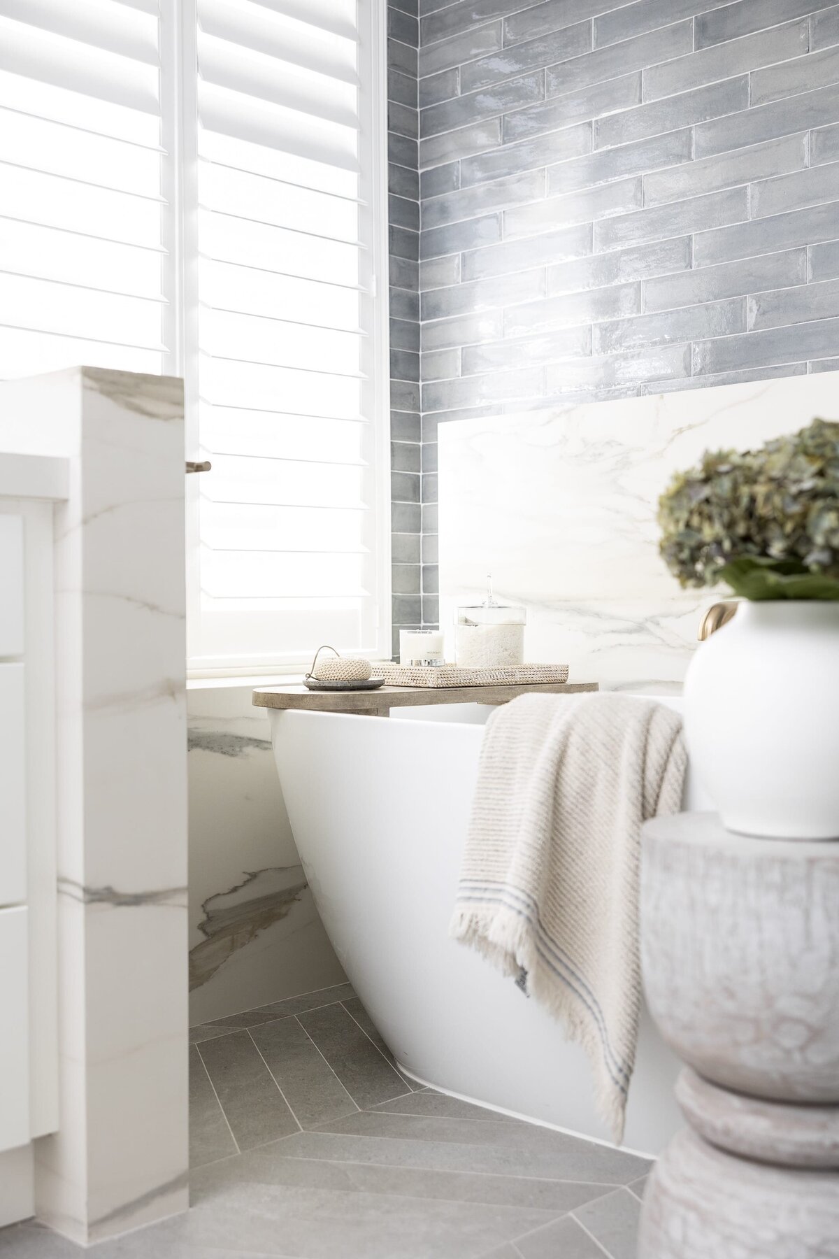 dewine design orlando interior designer contemporary coastal primary bathroom large tub with wooden table