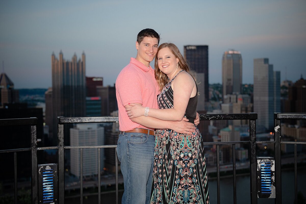 Engaged couple on Mt. Washington overlook at dusk in Pittsburgh, PA