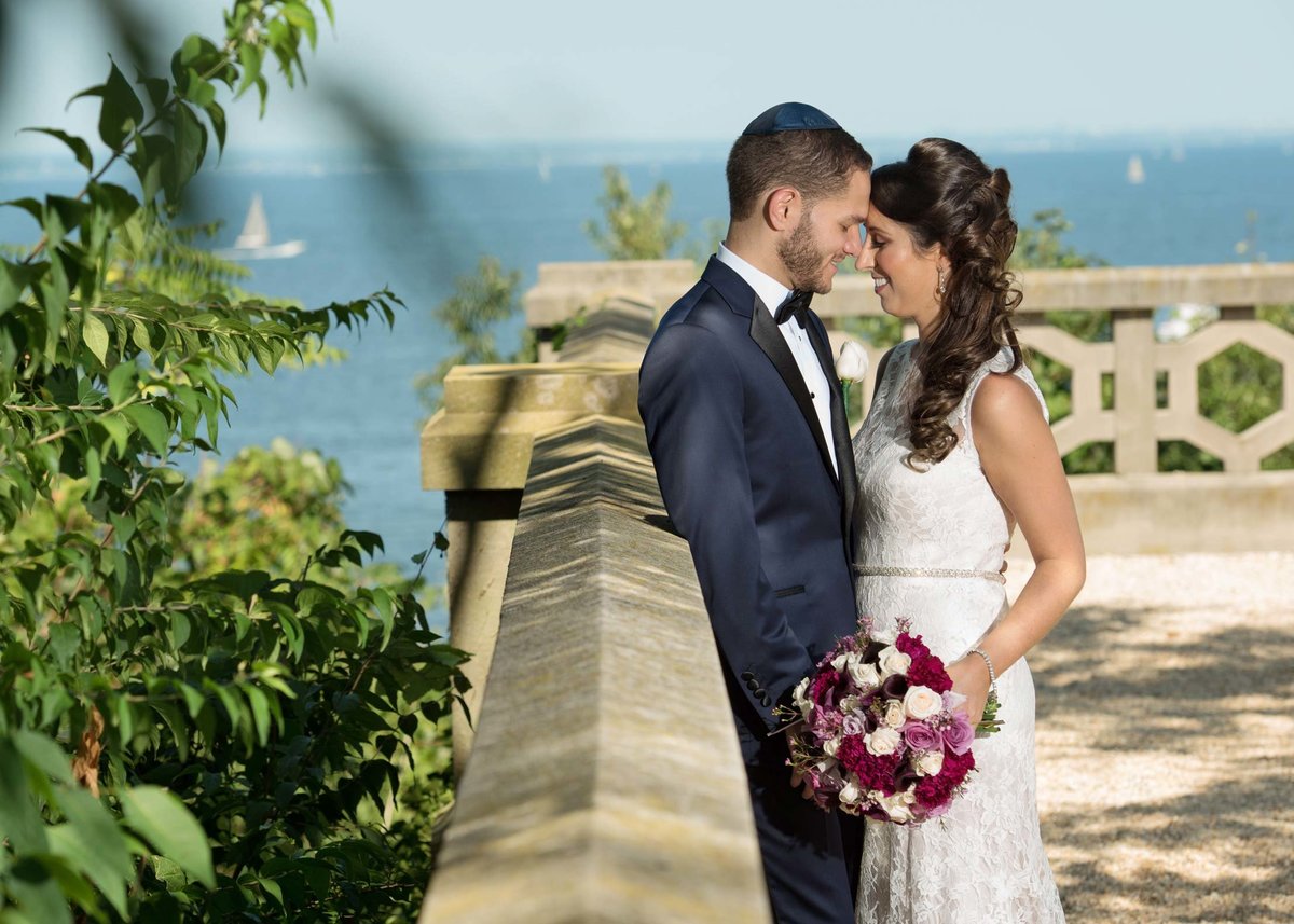 Bride and groom posing outside of Hempstead House