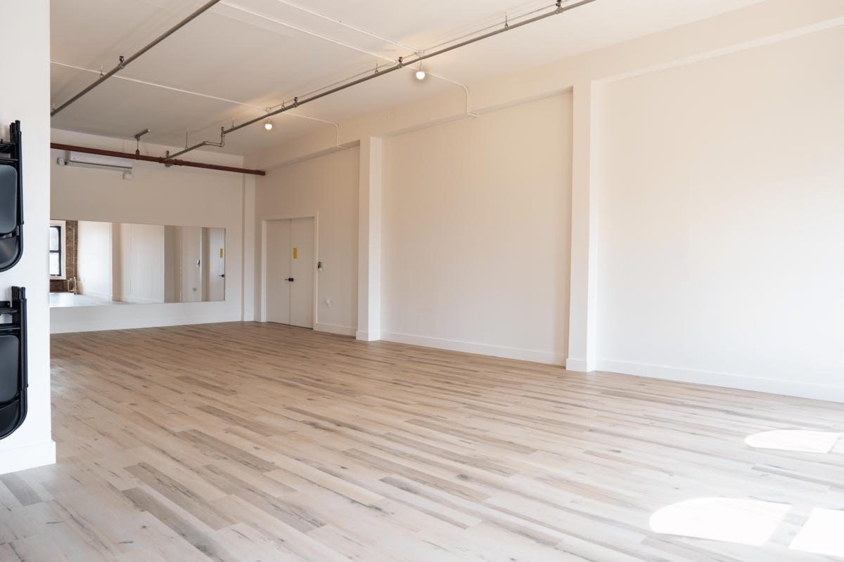 Large, airy studio space in Brooklyn, NY with brand new wood floors, equipped with yoga props.