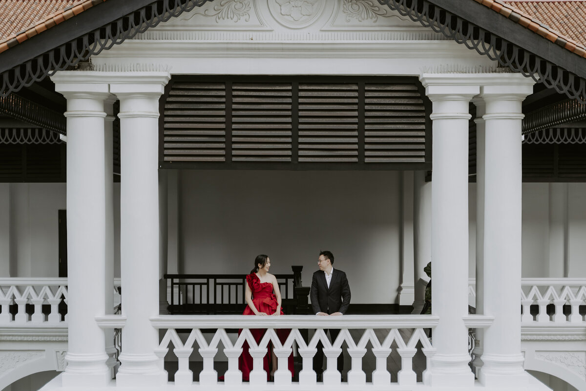 the couple pose on the  balcony of the raffles hotel