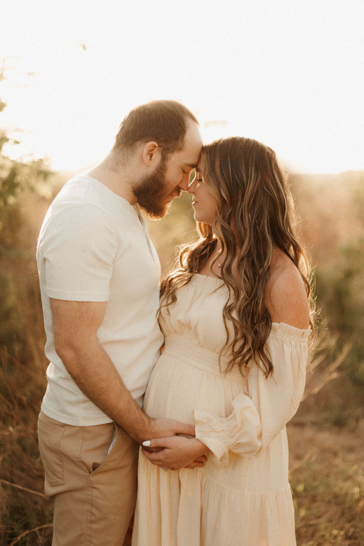 Pregnant woman in flowing gown during golden hour maternity photos in Franklin Tennessee