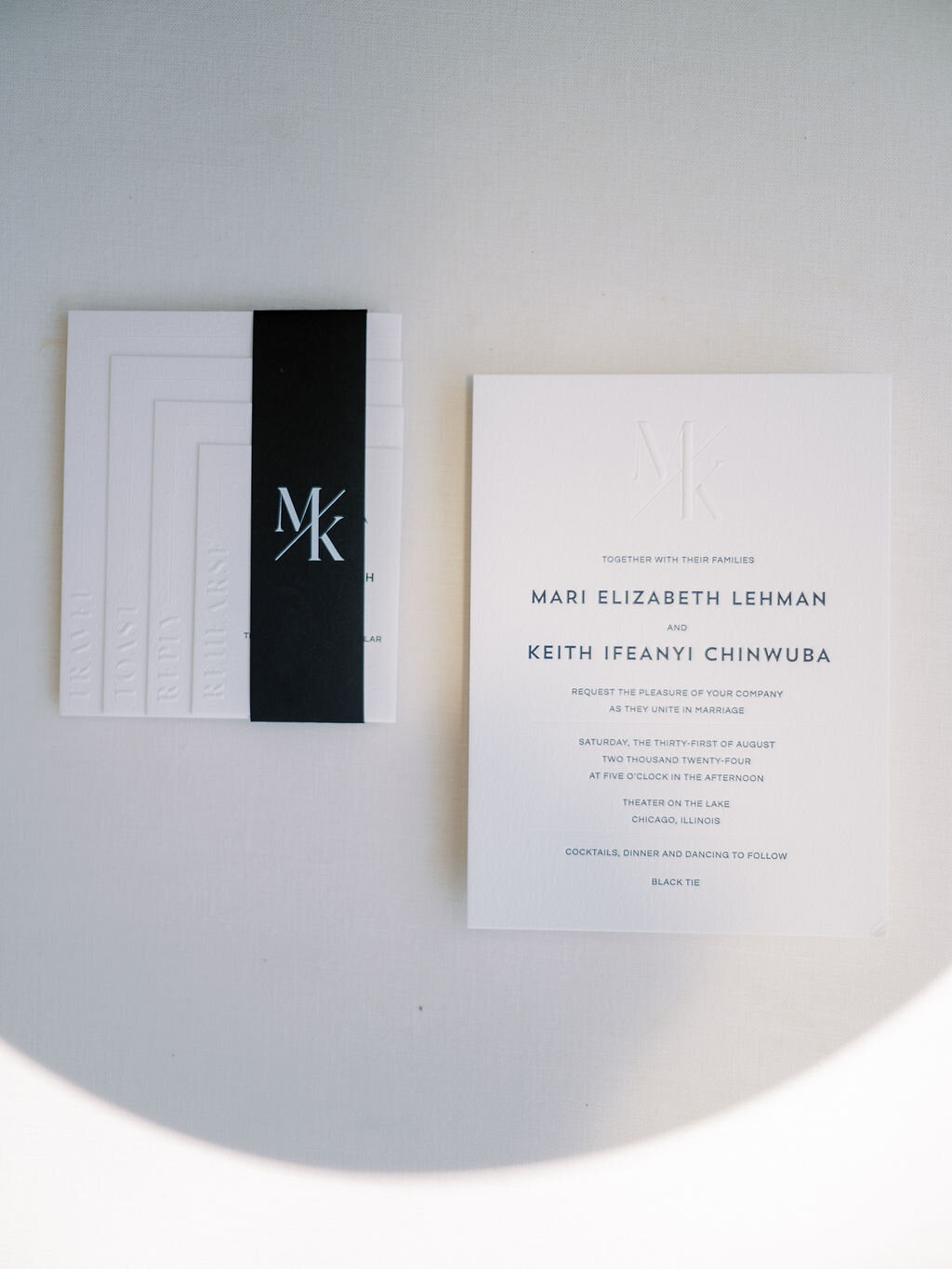 A wedding invitation set with classic typography and embossed details, featuring the couple’s initials and wedding details.