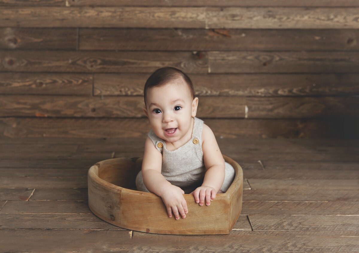 Toddler baby in wood basket