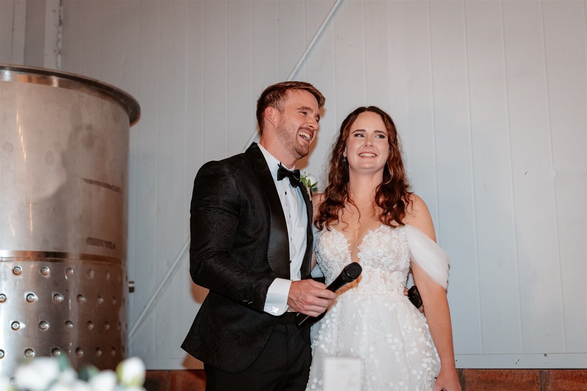 A charming moment captured as the couple shares a joyous dance amidst their wedding reception festivities.