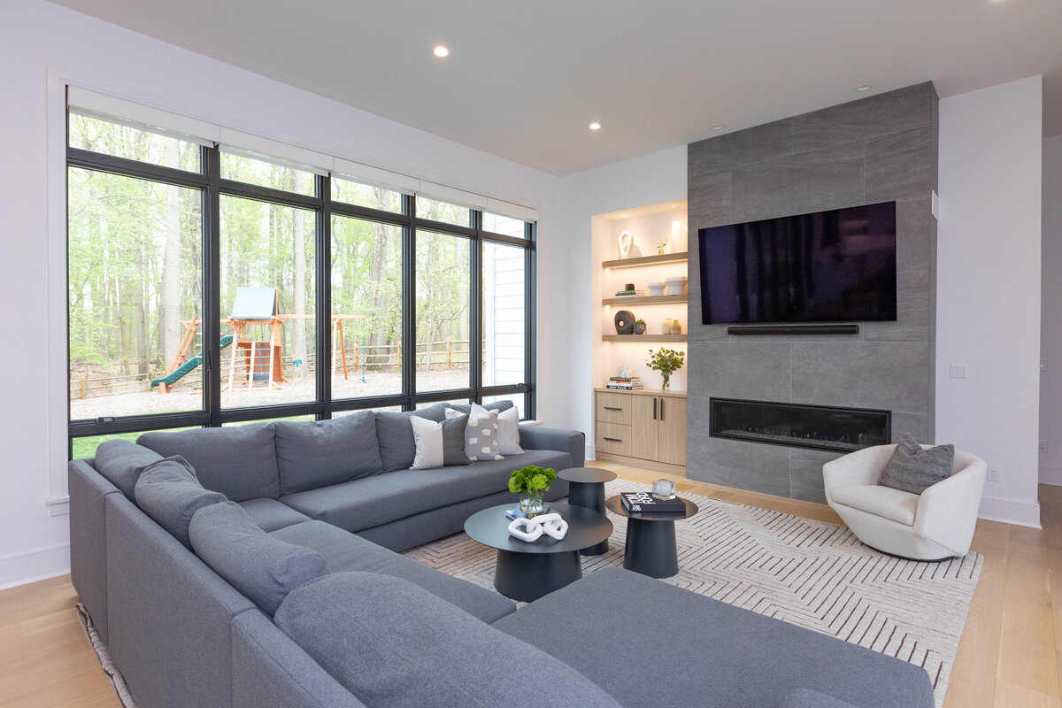 Modern livingroom with gray sofa and fireplace