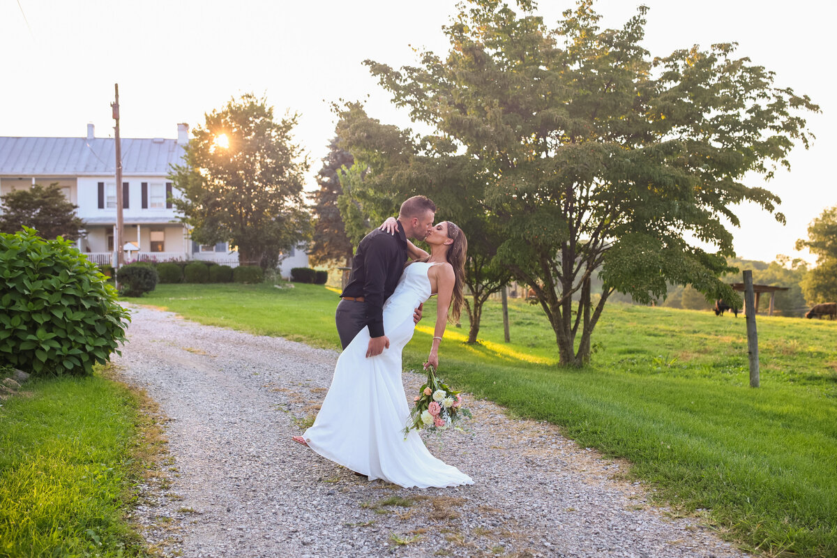 bride wearing form fitting white dress and groom wearing black shirt and gray pants on farm in Virginia by  DC elopement photographer Amanda Richardson Photography