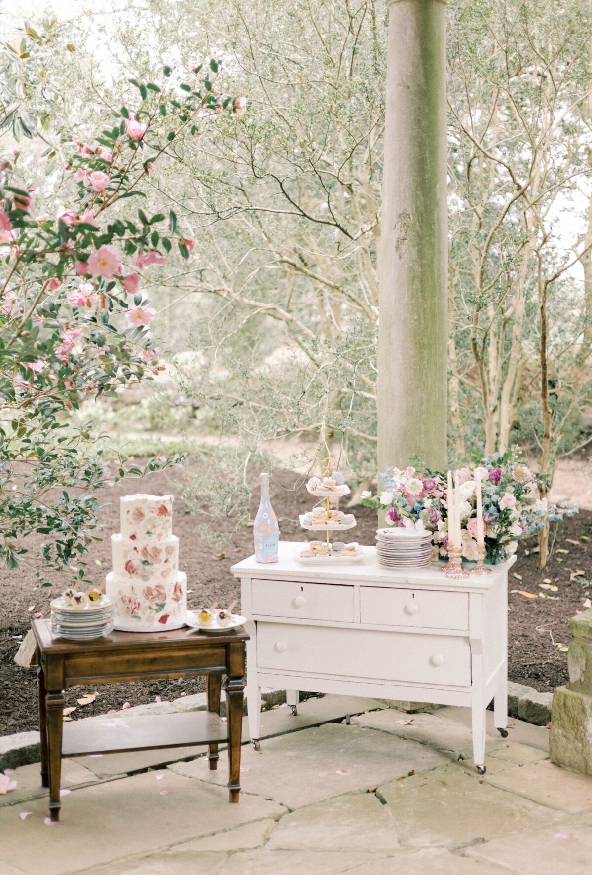 Wedding cake and dessert table on vintage tables.
