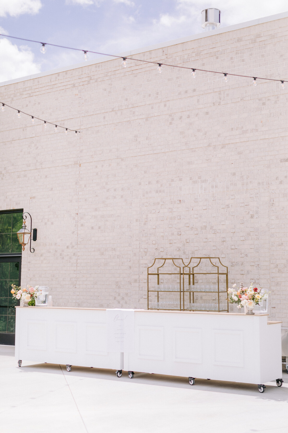 gold shelves behind white bar