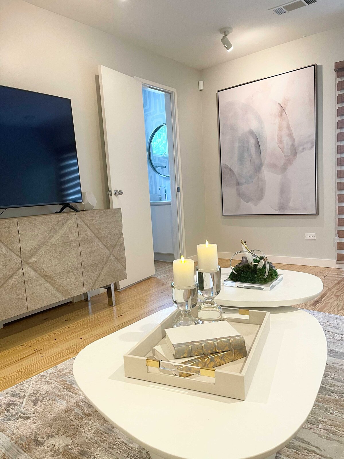 Innovative home interior contractor showcasing a living room with a close-up of a modern table and TV setup, featuring stylish decor and functional layout for a contemporary living space.