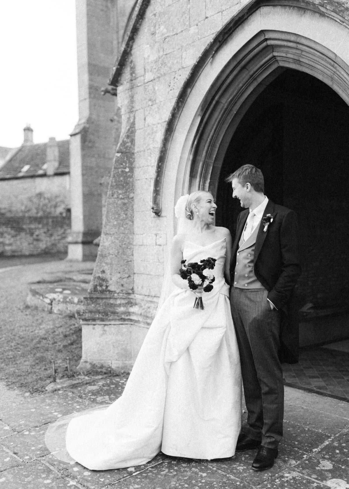 chloe-lowe-wedding-euridge-manor-cotswolds-ceremony-bride-groom-laughing