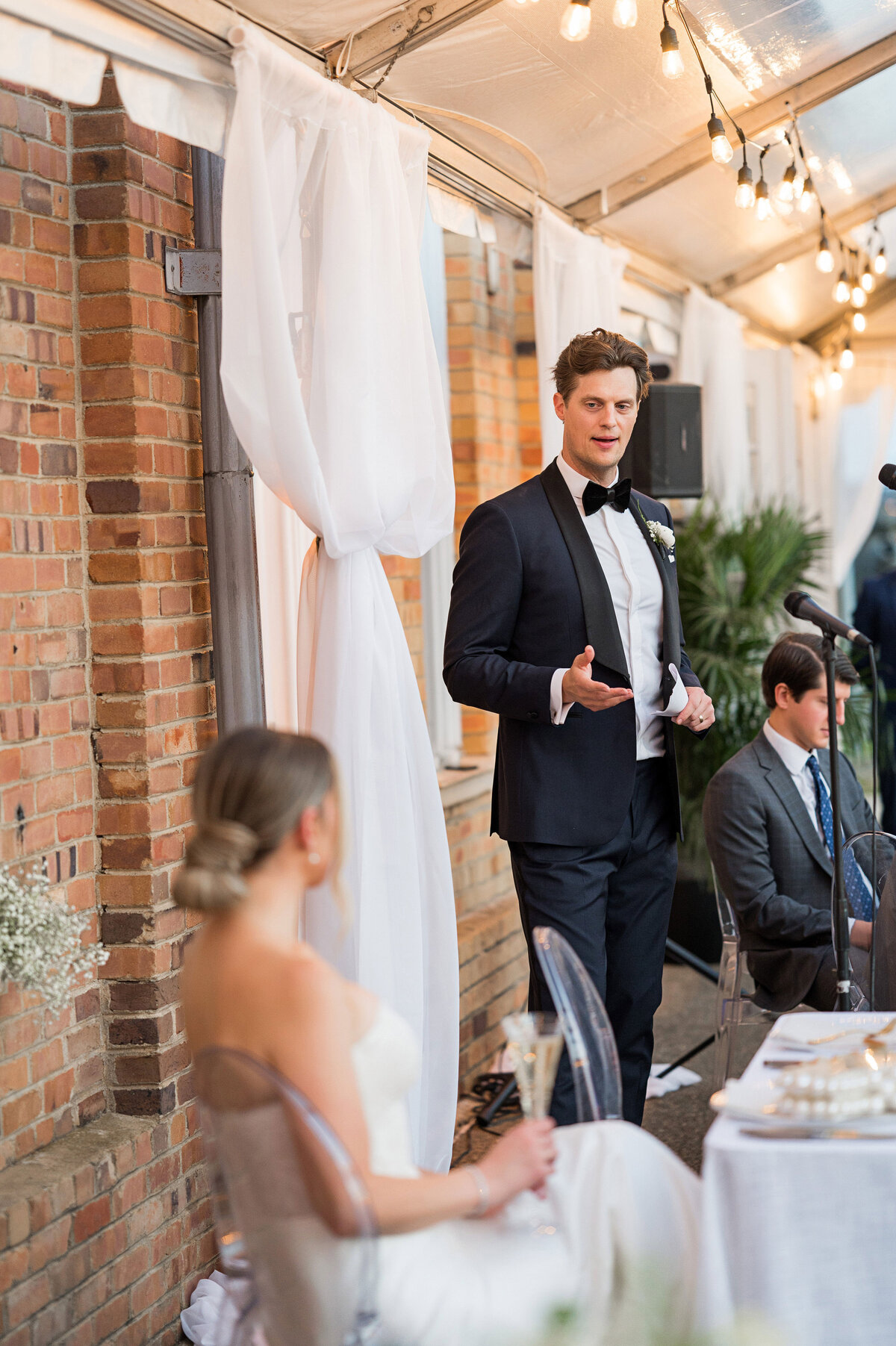 groom giving a toast on the wedding day at pump house