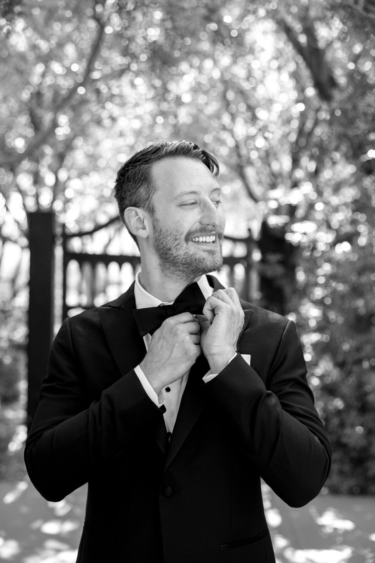 Groom adjusting bowtie getting ready at El Chorro wedding venue  in Arizona