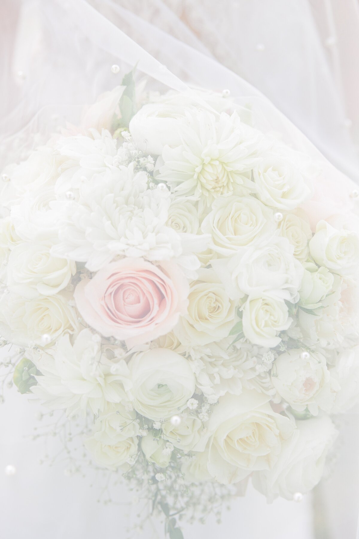 Wedding bouquet covered by wedding veil representing Boston wedding photography
