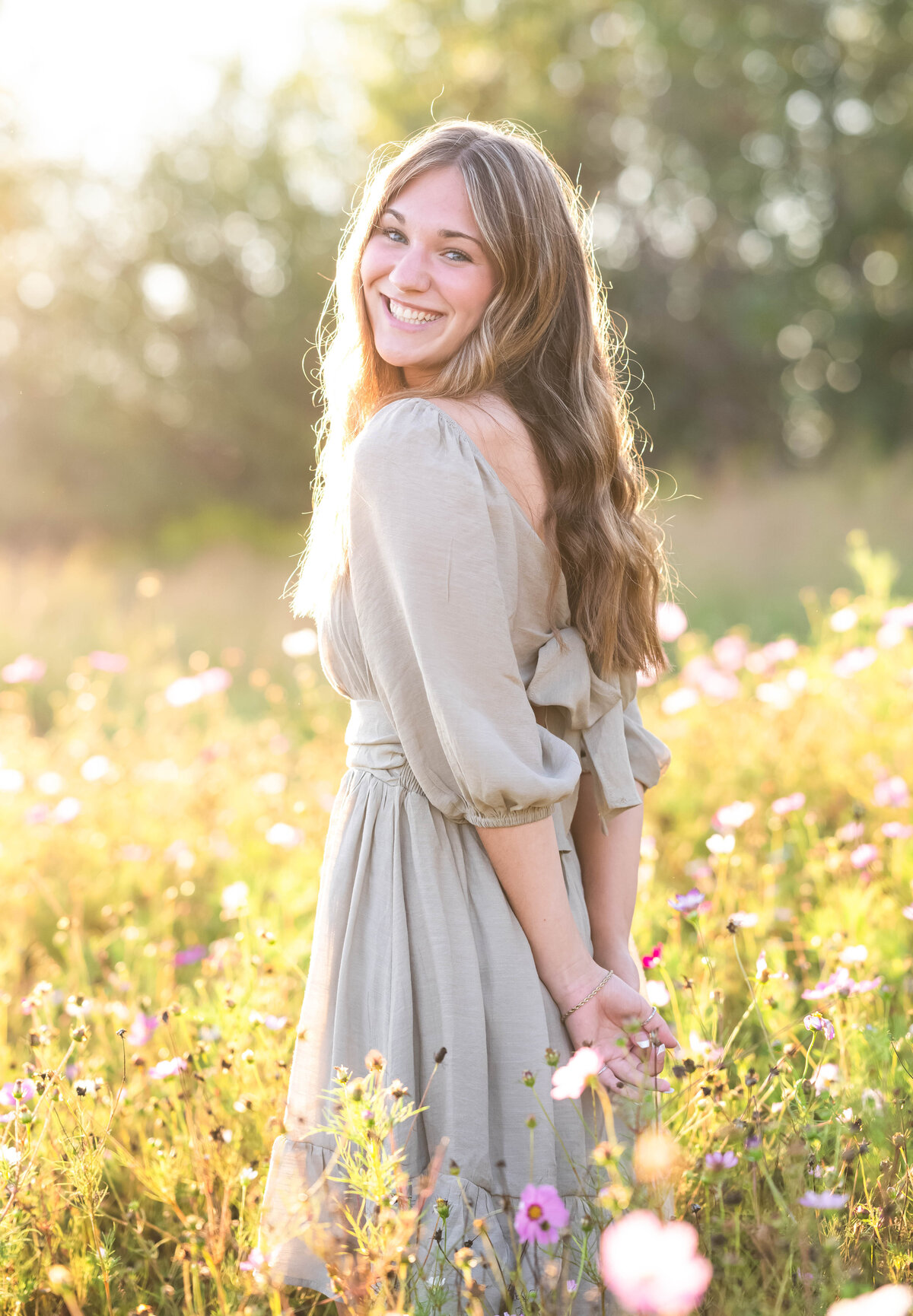 high school senior girl in field of flowers