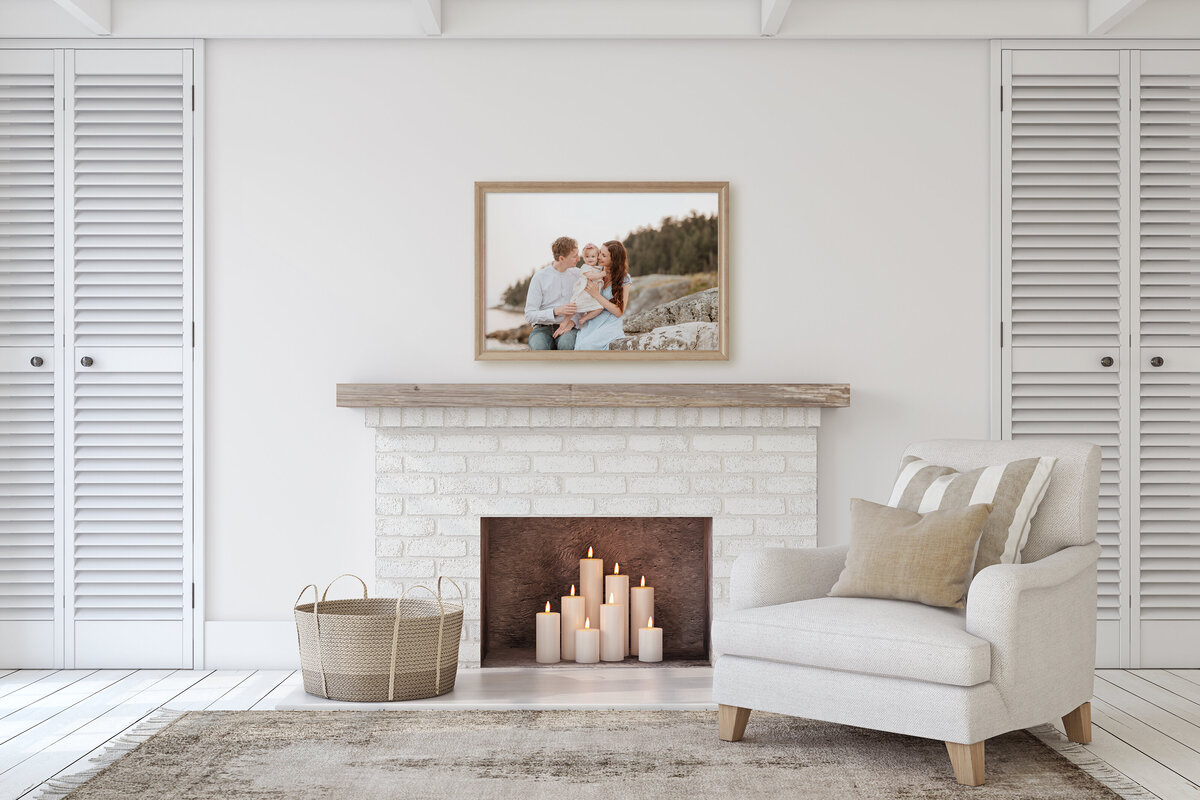 Family photo of mom, dad and baby in a frame above the fireplace.