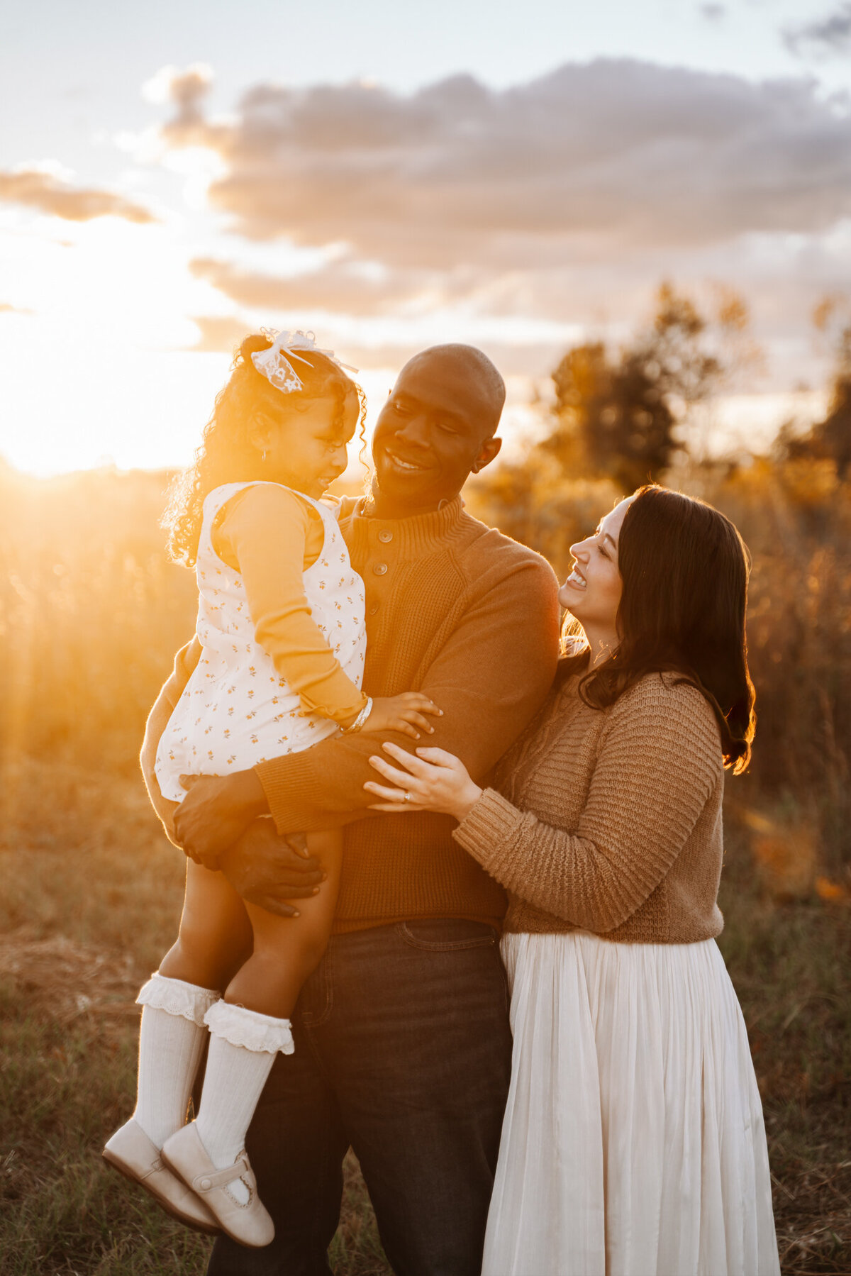 Dothan AL family mini session; photos taken outdoors at sunset with a lifestyle, cozy pose