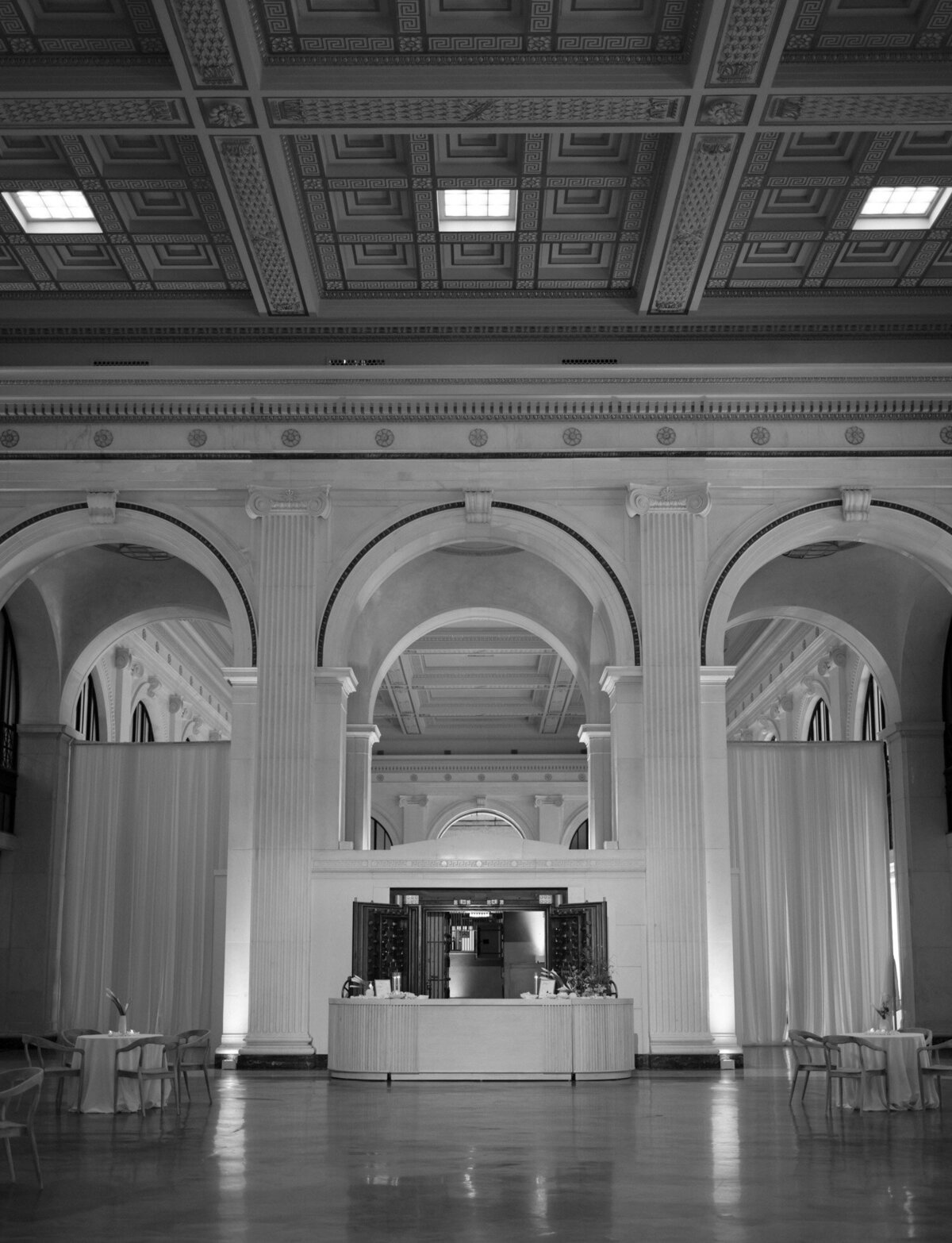 A bar is set up in front of a historic safe for a wedding at State Savings Bank in Detroit