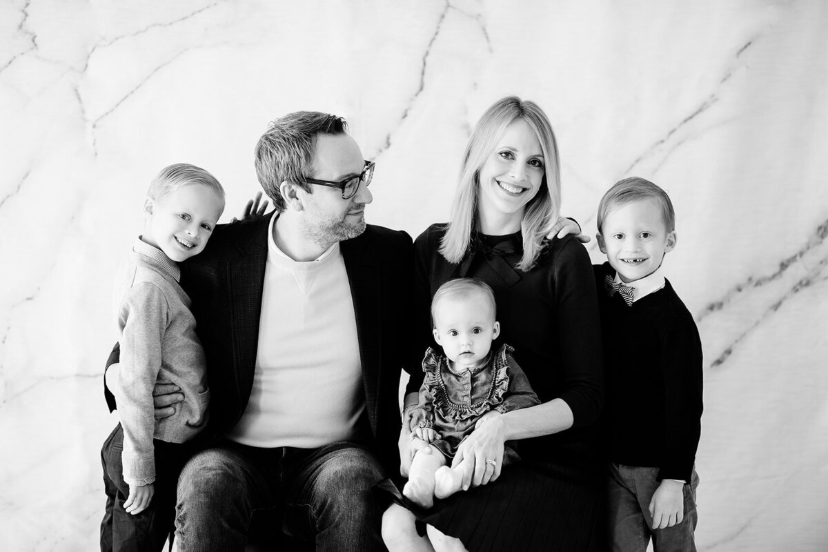 Black and white family portrait of two parents with three children