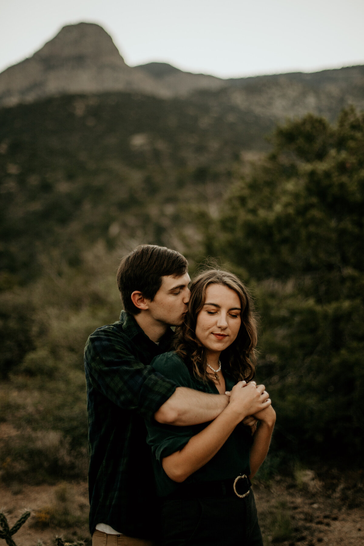 man kissing fiancés temple at the foothills in Albuquerque New Mexico