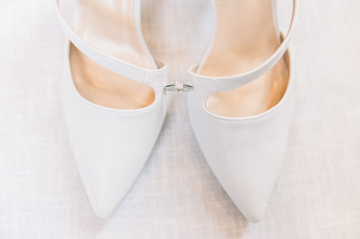 Niagara wedding photography showing off a wedding ring balanced on shoes