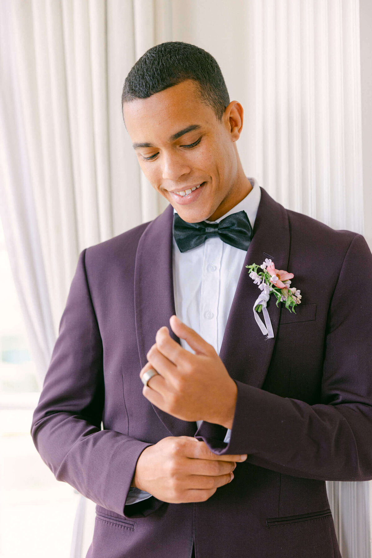 A wedding day portrait of the groom in his purple blazer at Hedsor House in the UK