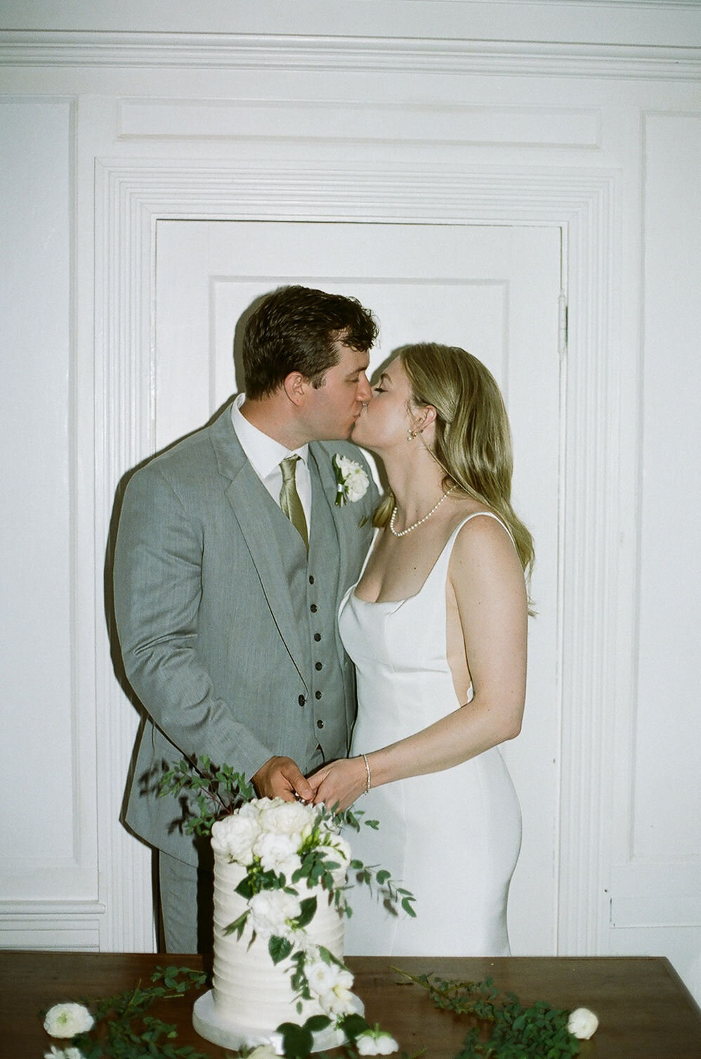 bride and groom cutting cake