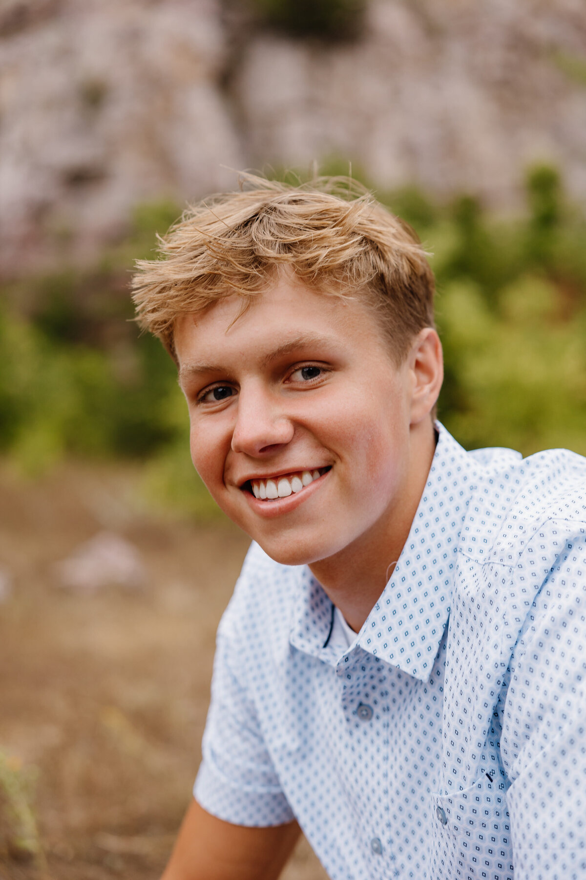 A young boy smiling in a field