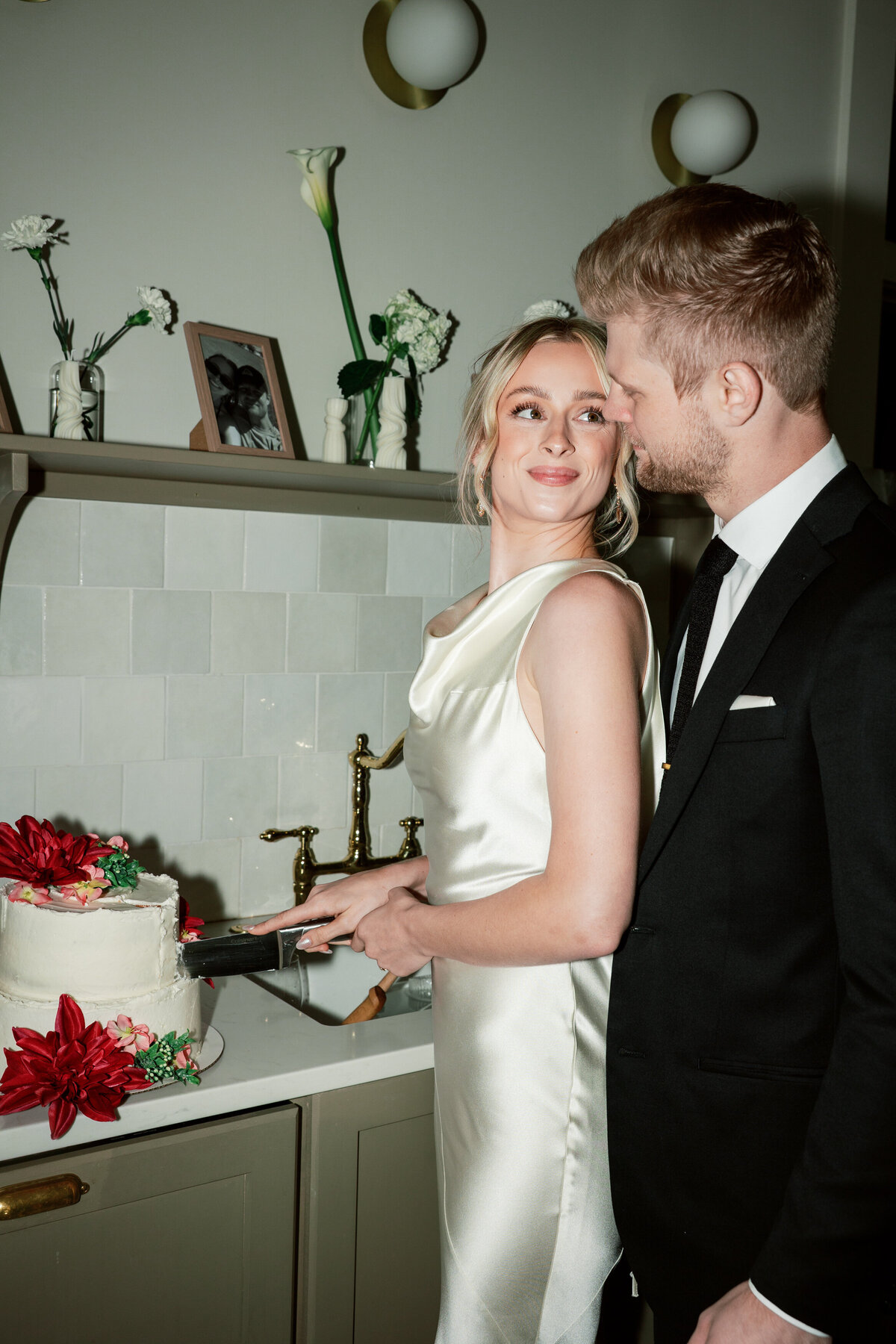Bride and groom cutting cake during Dayton, Ohio wedding, candid shot by Philadelphia wedding photographer.