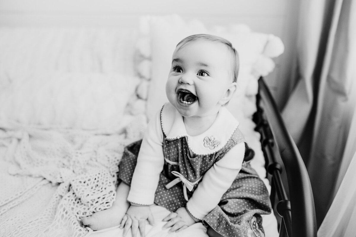 Black and white photo of Fort Collins baby laughing at her parents