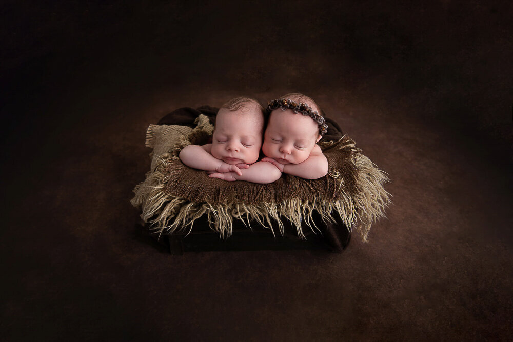 Twin boy and girl in a bucket with a all brown set up.