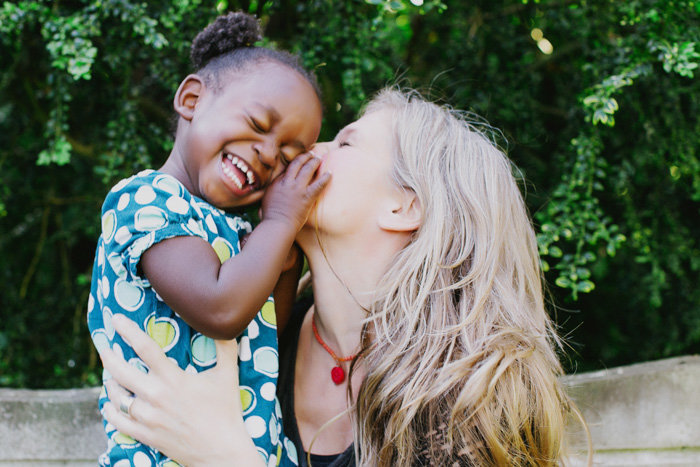 Mom gives child a kiss on the cheek