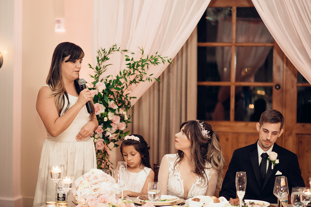 Wedding Photograph Of Bride Looking At The Woman Speaking In Microphone Los Angeles