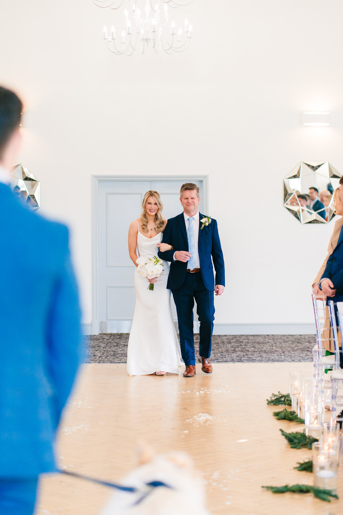 Groom watching his bride be walked down the aisle  at Mytton Fold Hotel taken by wedding documentary photographer and videographer Anthony Horseman