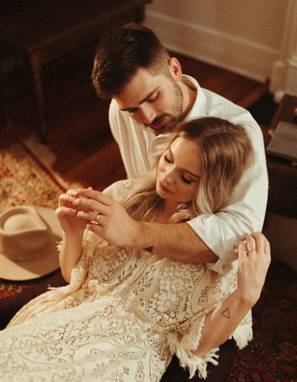 Boho bride and groom embracing each other in Airbnb elopement reception