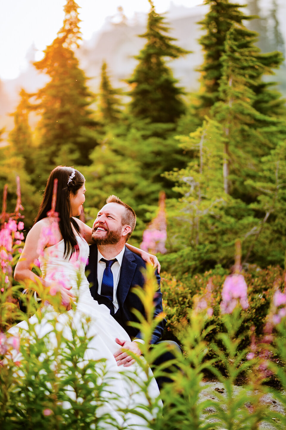 bride-sitting-on-groom-in-the-flowers-elopement-portraits