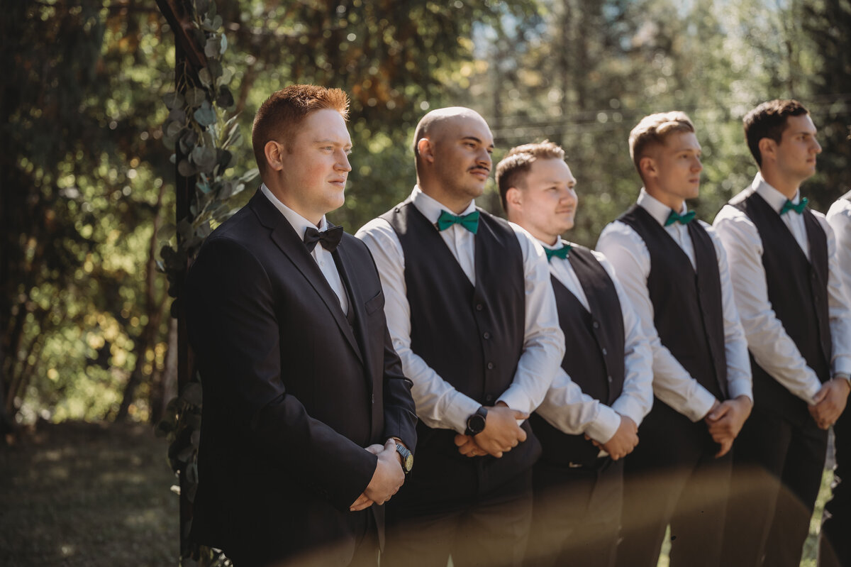 Groom and groomsmen standing at the front of the aisle in BC wedding