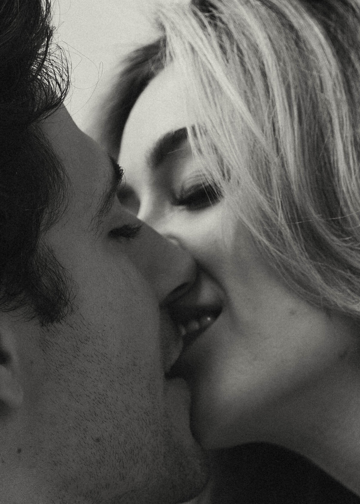 Close-up black and white image of a couple about to kiss—cinematic and editorial branding for Kenzie Digitized, a Tennessee-based wedding photographer.