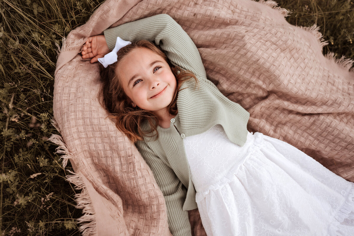 girl laying on blanket