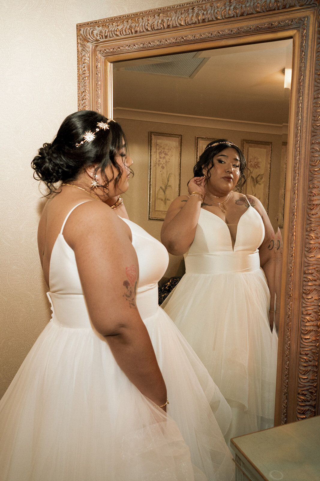 black bride fixing hair full length mirror