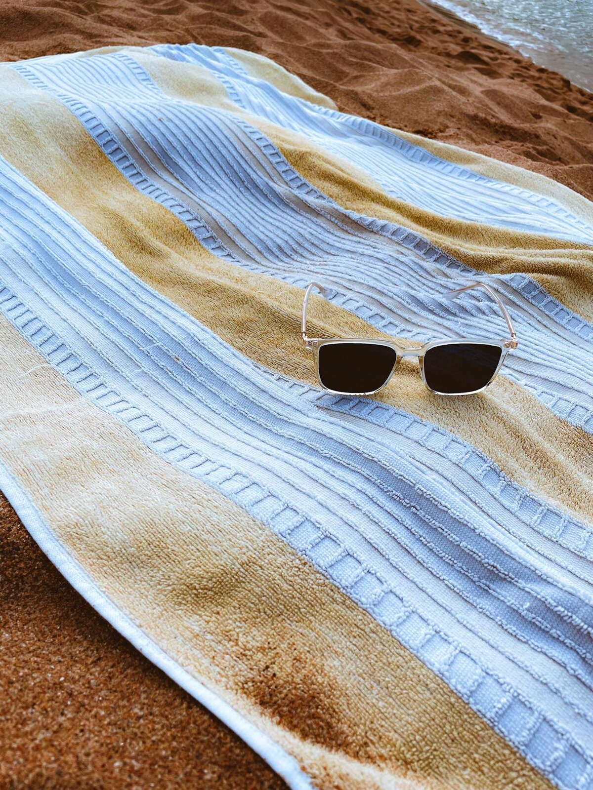 towel and sunglasses