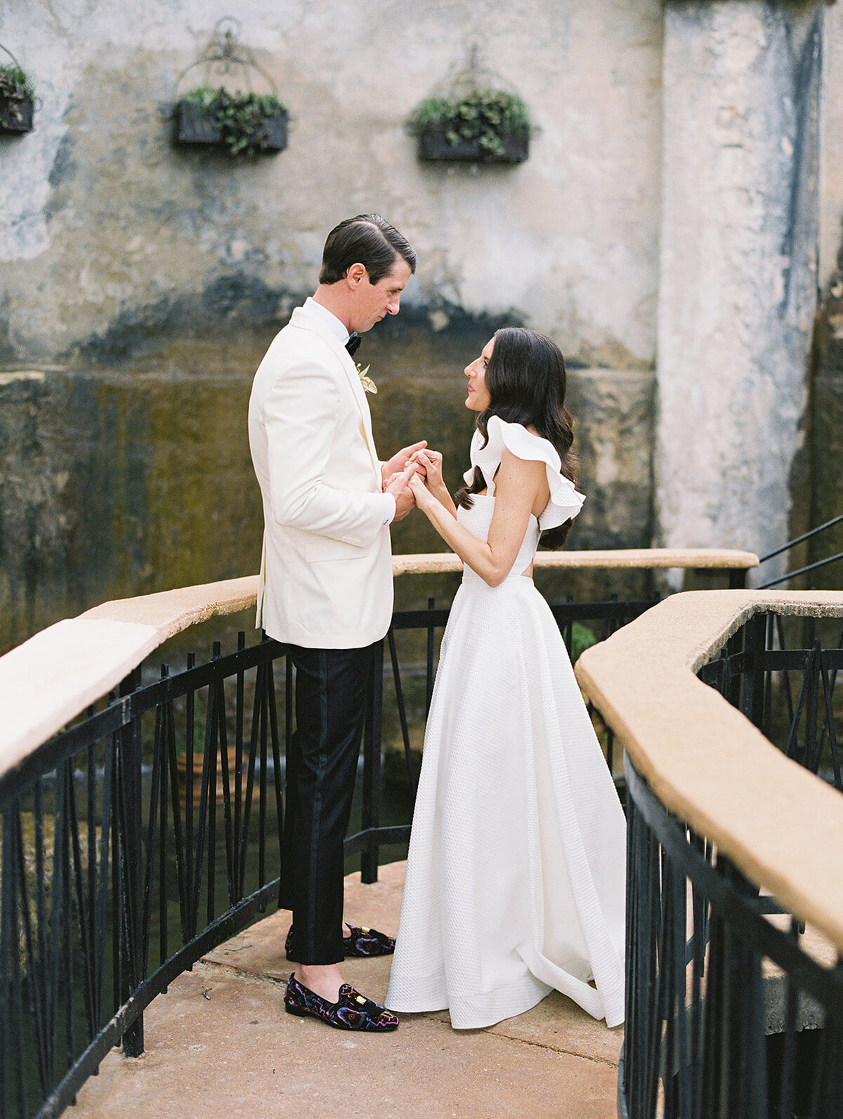 The bride and groom share a private moment before the reception next to the waterfall at Villa Antonia