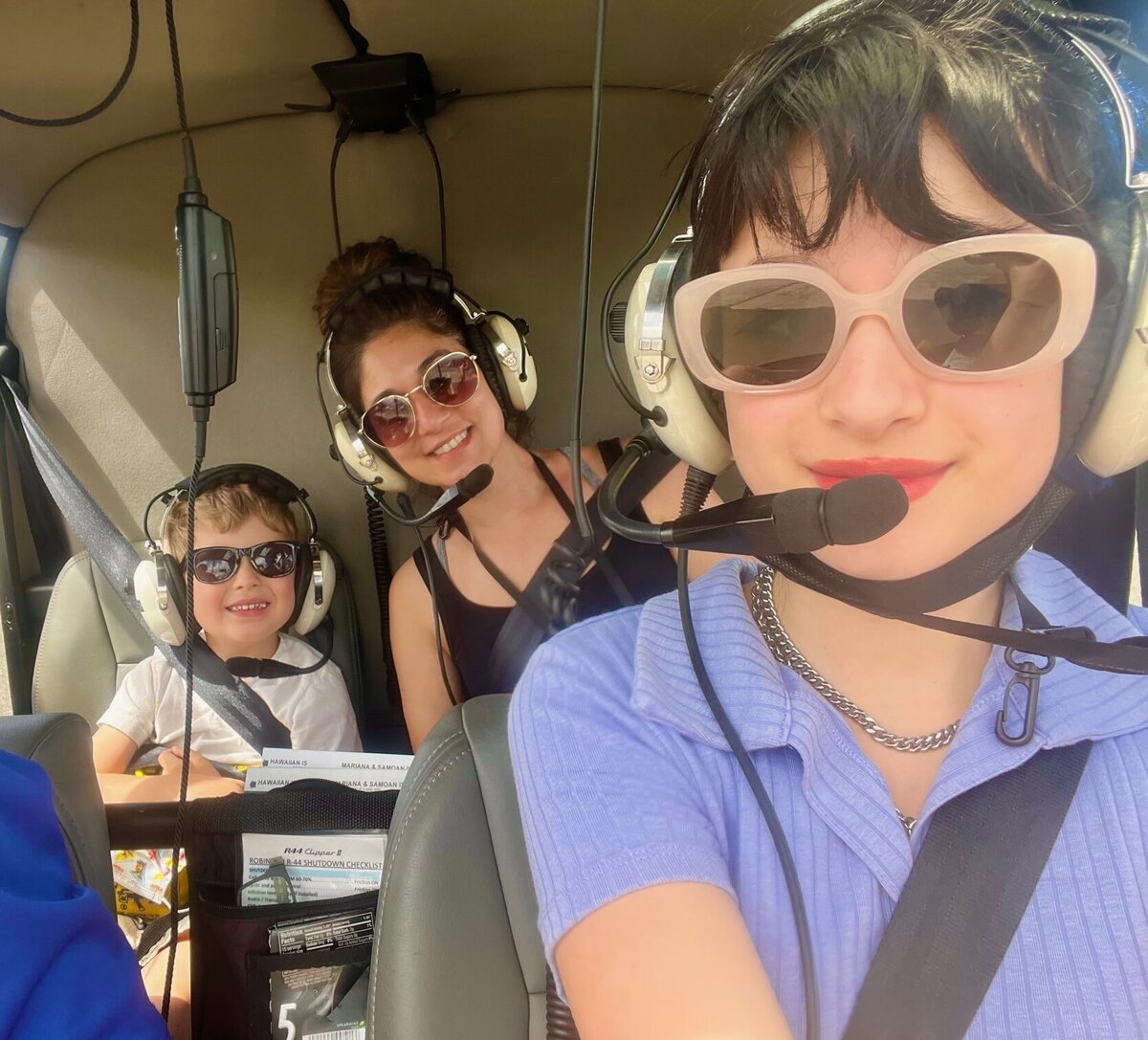 Sonia and her kids riding in a helicopter