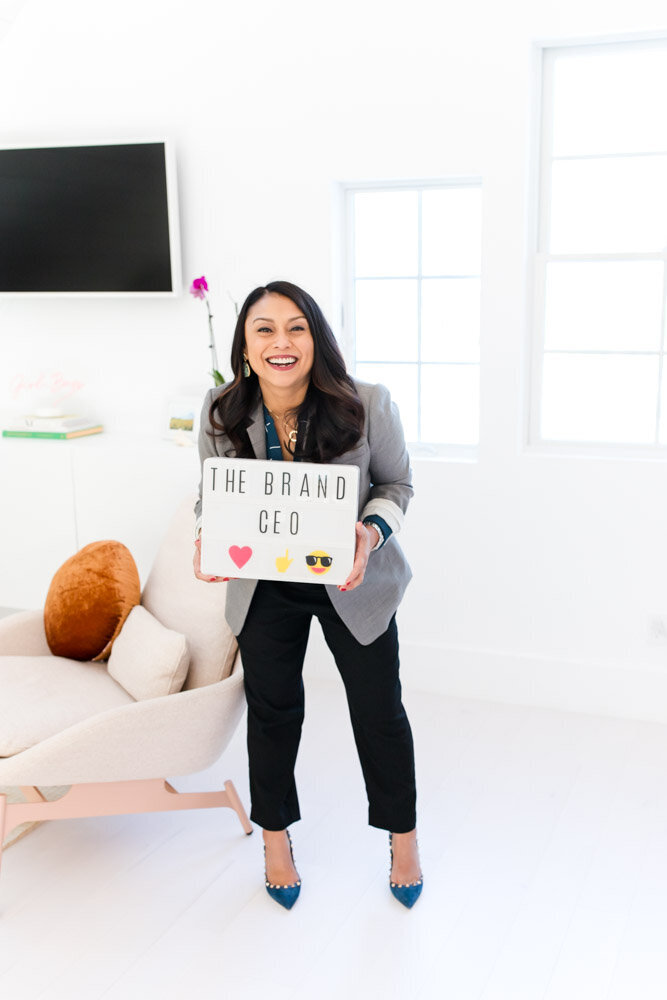 Female entrepreneur with Brand CEO sign